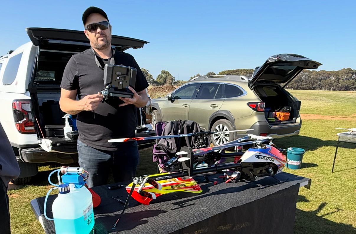Member packing up gear beside the truck at the field