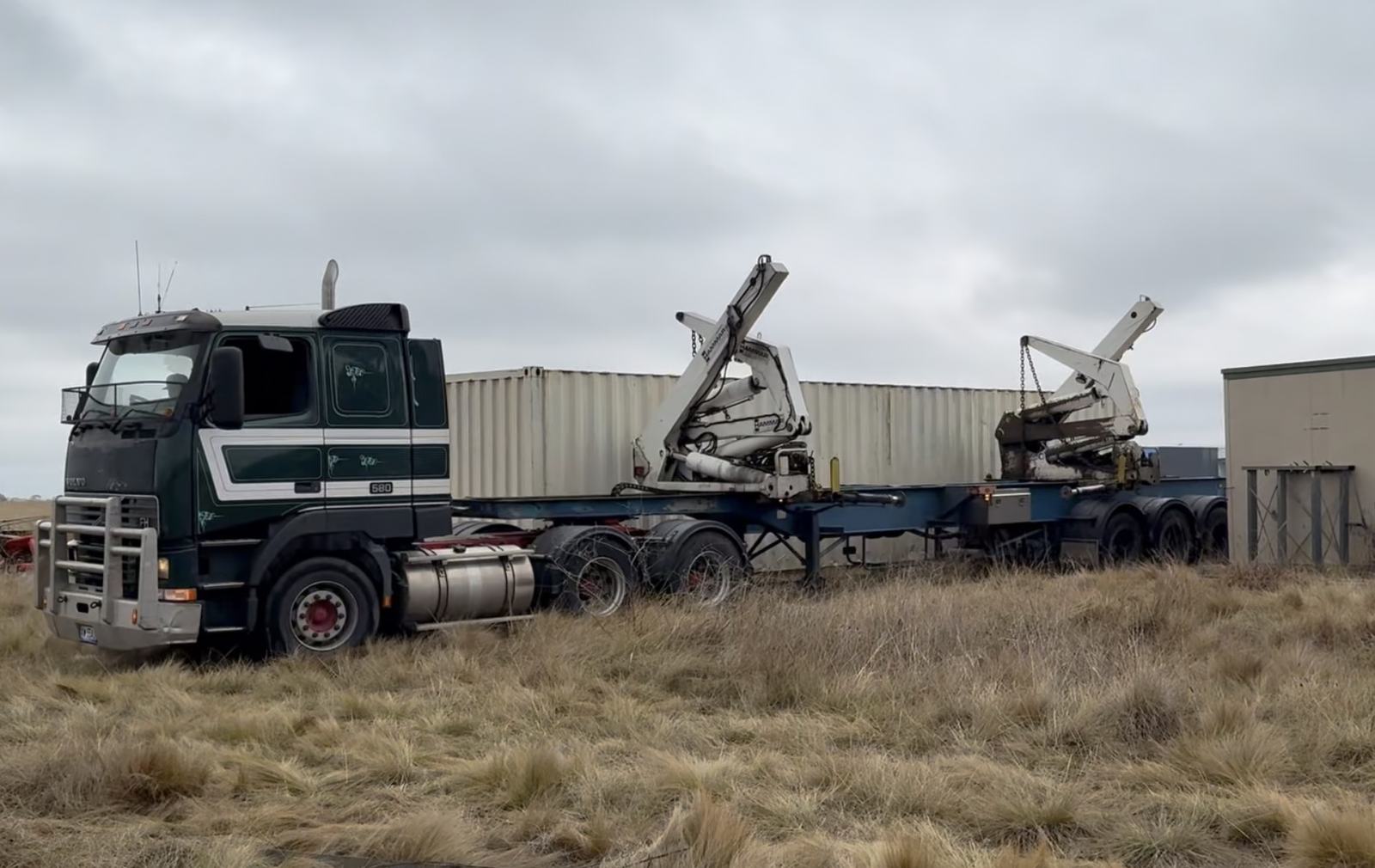 Truck hauling away the skip bin from the former site